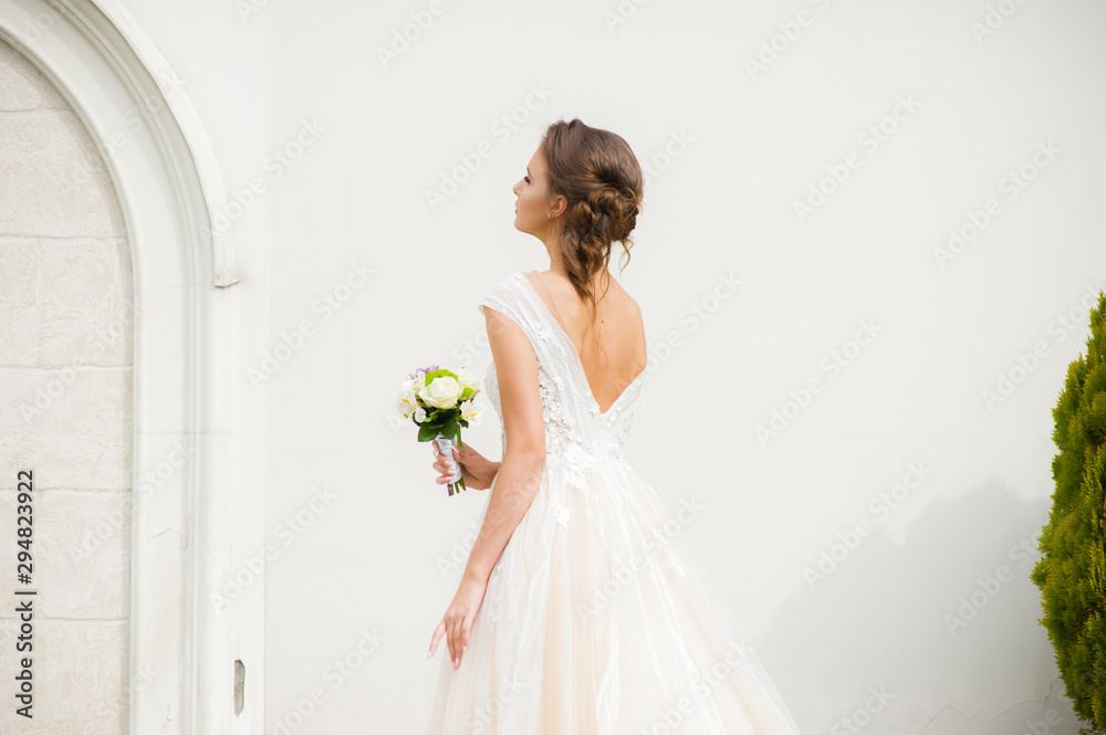 Beautiful happy bride in long wedding dress with wedding bouquet Beautiful happy bride in long wedding dress with wedding bouquet