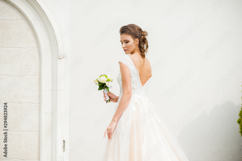 Beautiful happy bride in long wedding dress with wedding bouquet Beautiful happy bride in long wedding dress with wedding bouquet