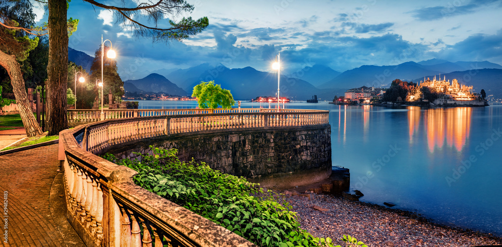 Fototapeta premium Great evening cityscape of Stresa town. Picturesque summer susnset on Maggiore lake with Bella island on background, Province of Verbano-Cusio-Ossola, Italy, Europe. Traveling concept background.