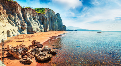 Gorgeous spring landscape of famous Xi Beach. Sunny morning scene of Cephalonia island, Greece, Europe. Attractive seascape of Ionian Sea. Traveling concept background.
