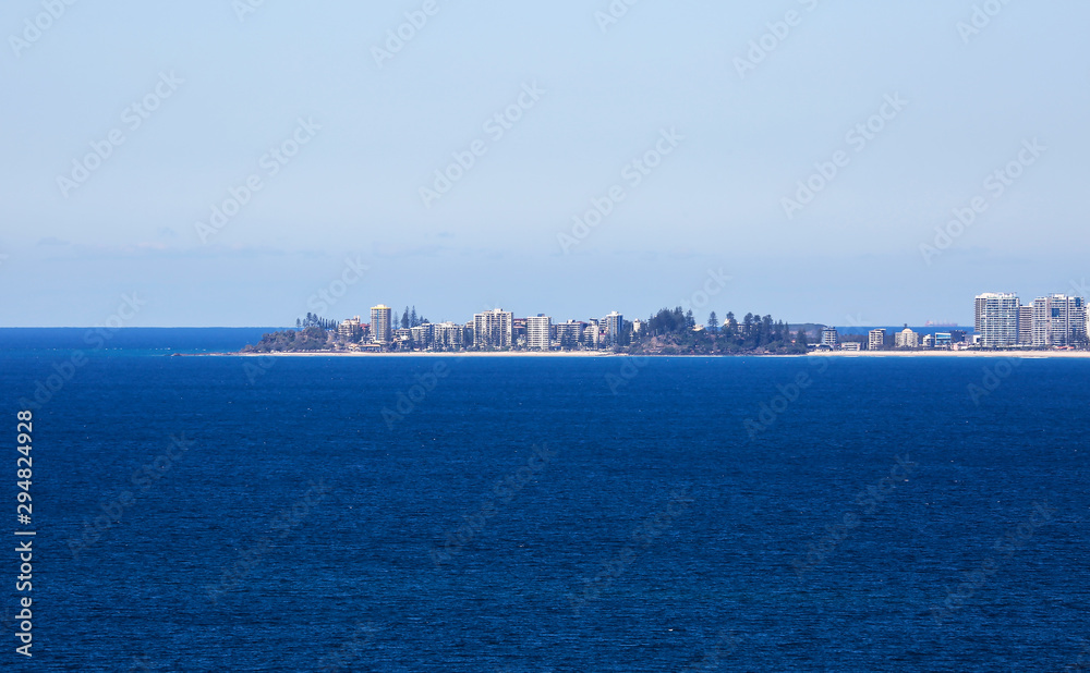 The high-rise towers of Coolangatta, Queensland, Australia, jutting out into the vivd blue waters of the Pacific Ocean.