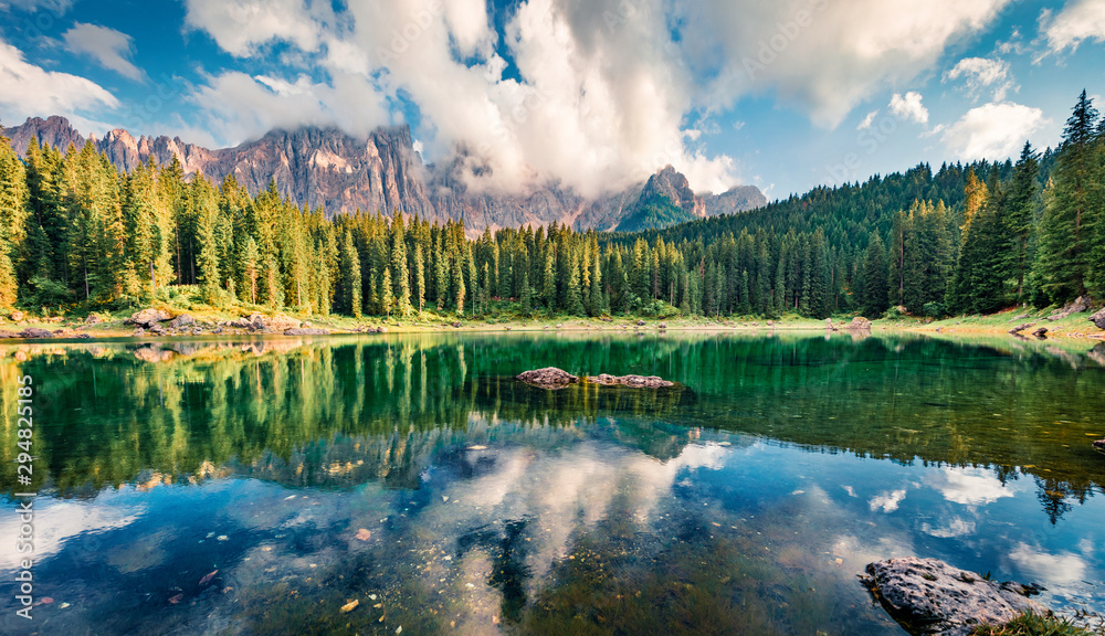 Colorful summer view of Carezza (Karersee) lake. Wonderful morning scene of Dolomiti Alps, Province of Bolzano, South Tyrol, Italy, Europe. Beauty of nature concept background.