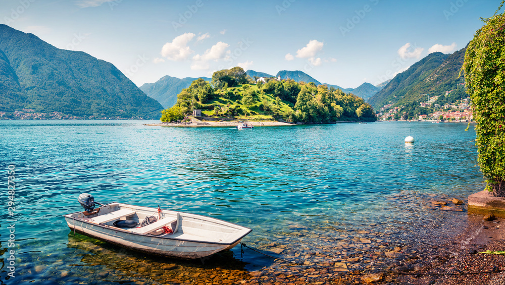 Picturesque sunny day on Como lake. Bright morning landscape of Comocina island from the hiil of Ossuccio village, Province of Como, region Lombardy, Italy, Europe. Traveling concept background.