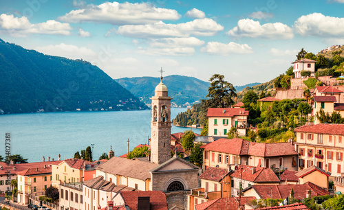 Attractive summer view of Como lake. Captivating morning cityscape of Moltrasio town with spire of S. Agata church, Province of Como, Lombardy region, Italy, Europe. Traveling concept background.