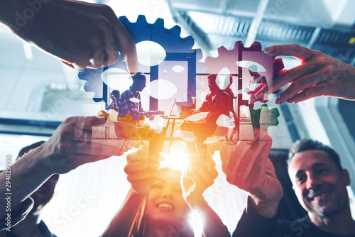 Business team connect pieces of gears. Teamwork, partnership and integration concept. double exposure with light effects photo