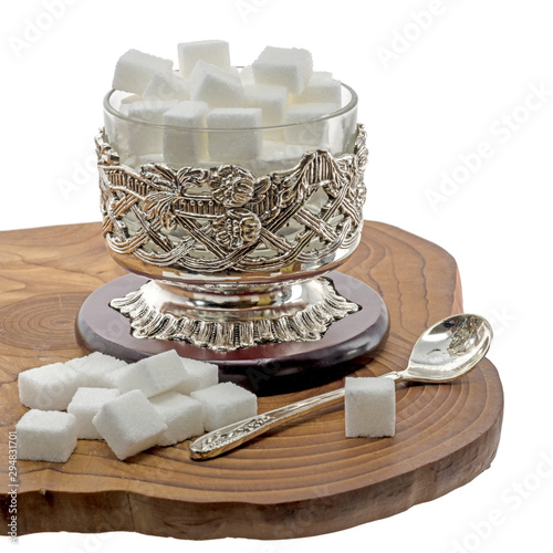Cuadro en lienzo Old sugar bowl from the Orient on dark wood isolated on white