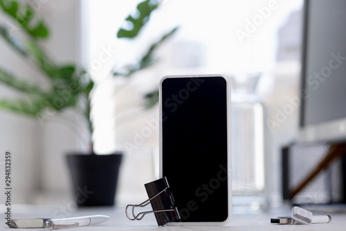 Mock up empty black smartphone screen on blured background. Copyspace, negative space for your advertising, office and business style.