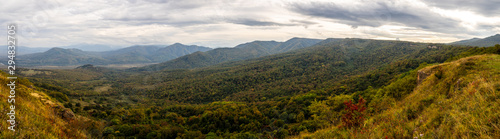 Panoramic views of the mountains and yellow-orange trees in autumn. The Caucasus strict nature reserve in Russia