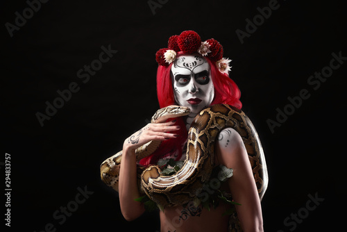 Sugar skull model with big snake posing.