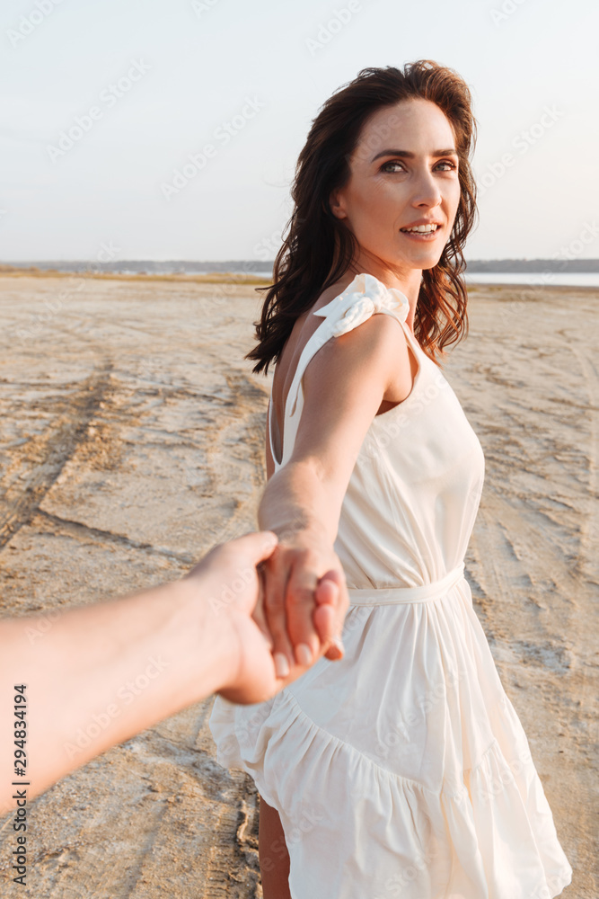 Smiling beautiful young woman wearing summer dress Smiling beautiful young woman wearing summer dress