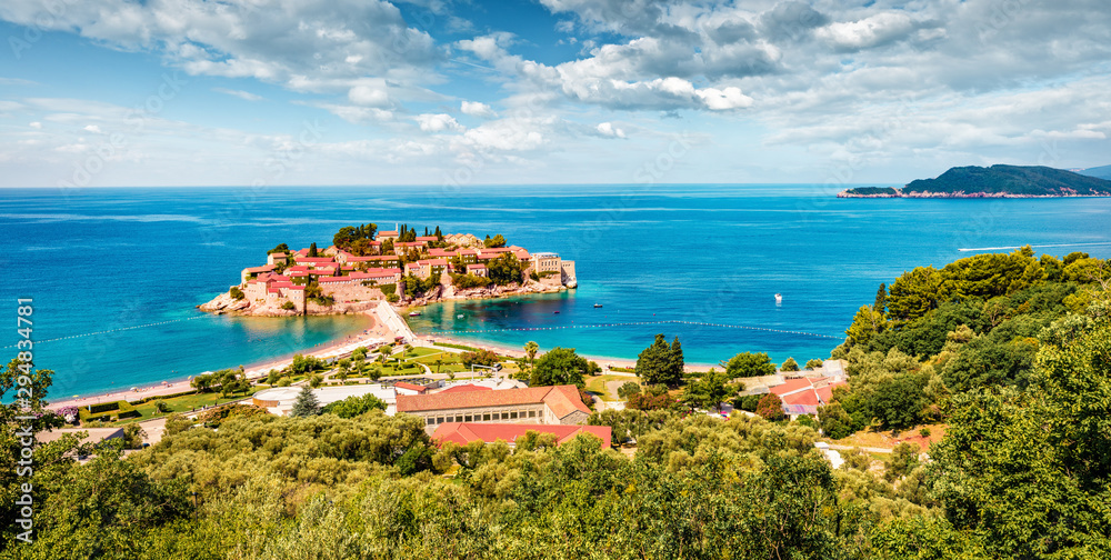 Aerial summer cityscape of Sveti Stefan town. Panoramic morning seascape of Adriatic sea, Montenegro, Europe. Beautiful world of Mediterranean countries. Traveling concept background.