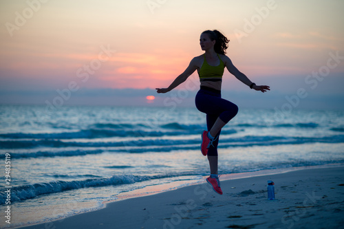 fitness sports woman on seashore in evening training