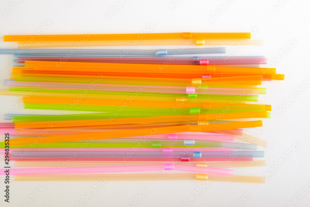 Multicolored plastic tubules on a white background