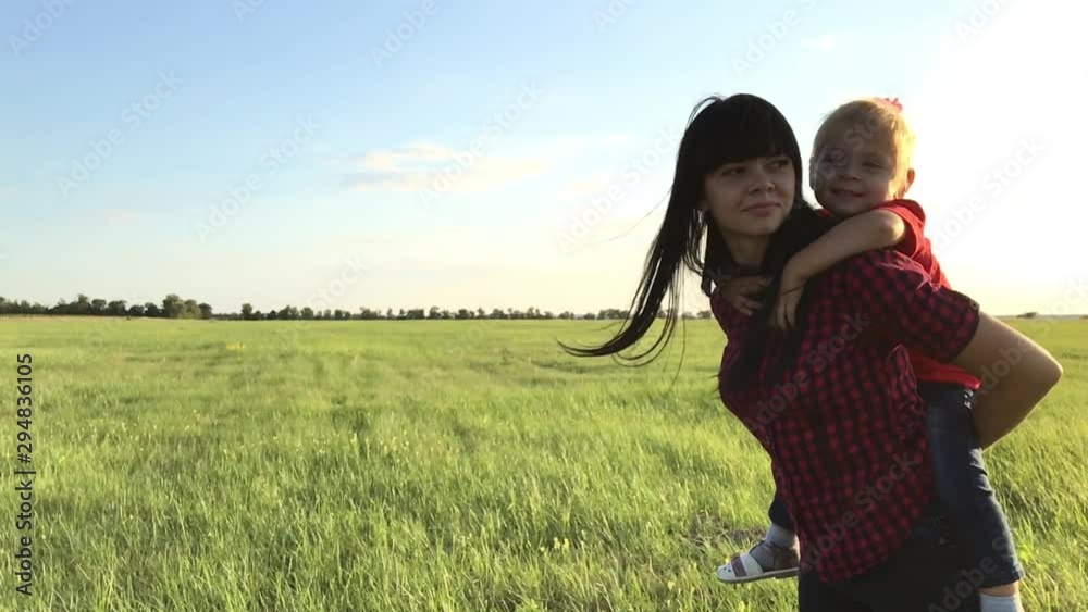 happy family concept a mom and daughter play outdoors slow motion video. mother are running carries daughter on her lifestyle back playing little girl laughing. happy family outdoor recreation happy family concept a mom and daughter play outdoors slow motion video. mother are running carries daughter on her lifestyle back playing little girl laughing. happy family outdoor recreation