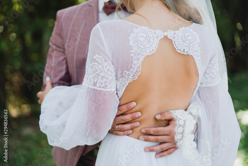 Love on wedding day. Stylish caucasian bride and groom from the back.
