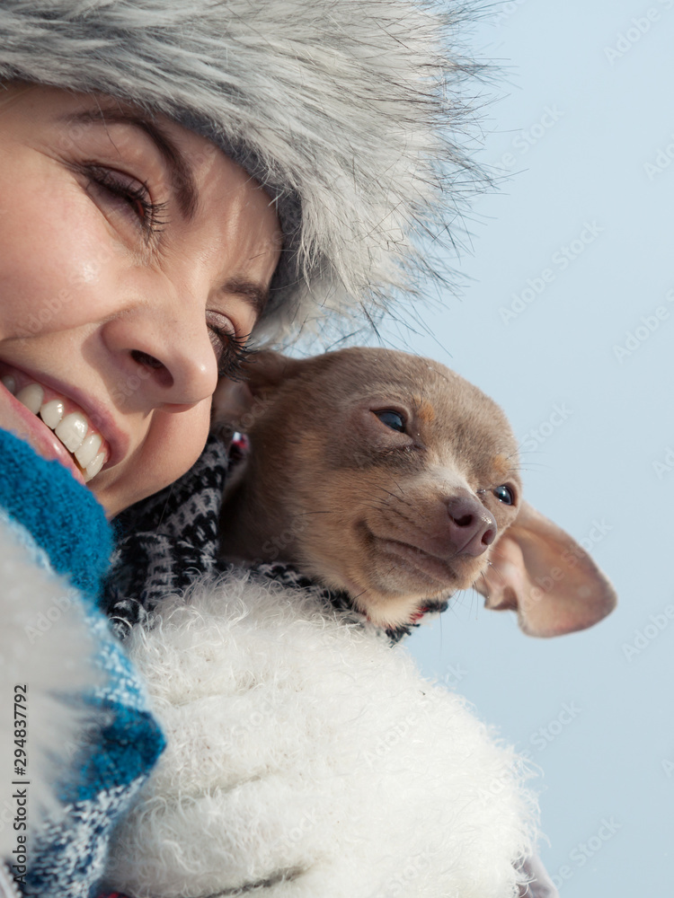 Woman hug warming her dog in cold day Woman hug warming her dog in cold day