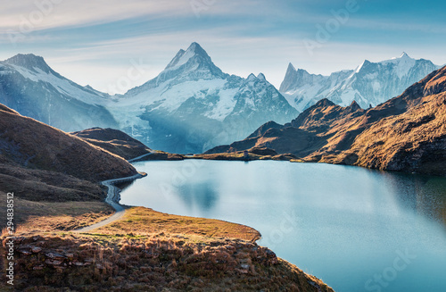 Gorgeous evening panorama of Bachalp lake / Bachalpsee, Switzerland. Exotic autumn sunrise in Swiss alps, Grindelwald, Bernese Oberland, Europe. Beauty of nature concept background. photo