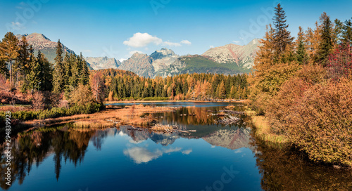 Fototapeta Naklejka Na Ścianę i Meble -  Colorful autumn panorama of Strbske pleso lake. Calm morning view of High Tatra National Park, Slovakia, Europe. Beauty of nature concept background..