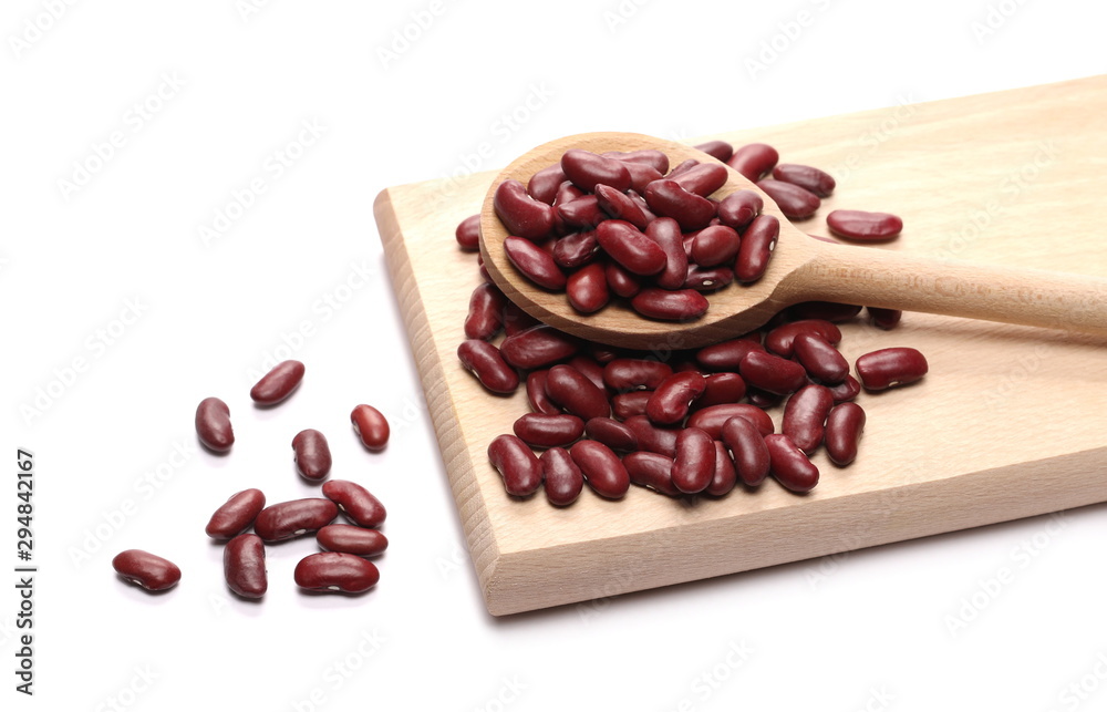 Fototapeta premium Red beans in wooden spoon on cutting, chopping board isolated on white background