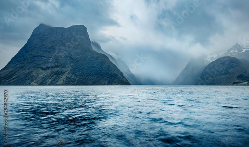 Dark evening scene of Hjorundfjorden fjord, Orsta municipality, More og Romsdal county. Dramatic view of Norway. Beauty of nature concept background. © Andrew Mayovskyy