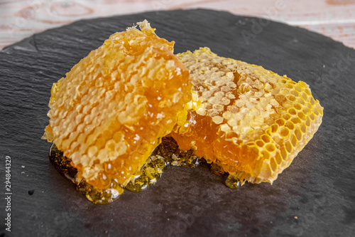 Slide sweet honeycombs on a stone board, organic product
