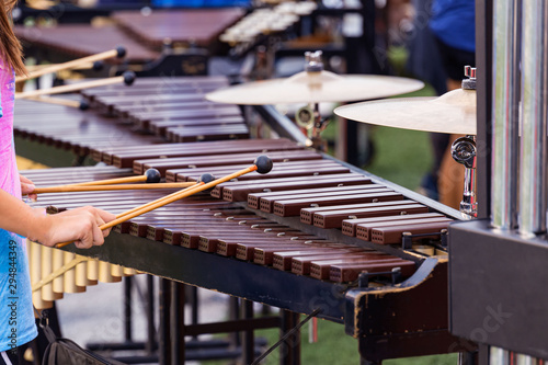 several sideline percussionists performing at an outdoors rehearsal