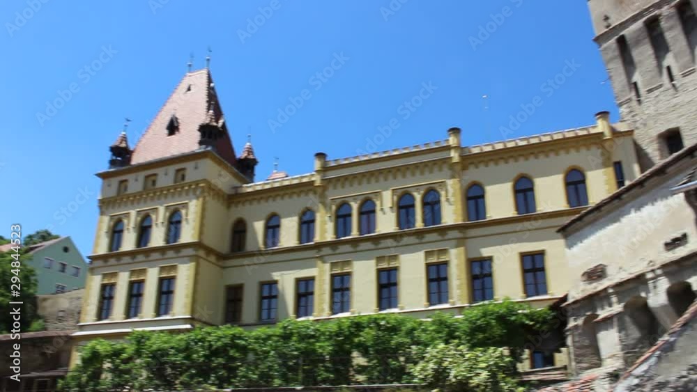 Left-Right Pan view in front of the Sighisoara Clock Tower. HD Video