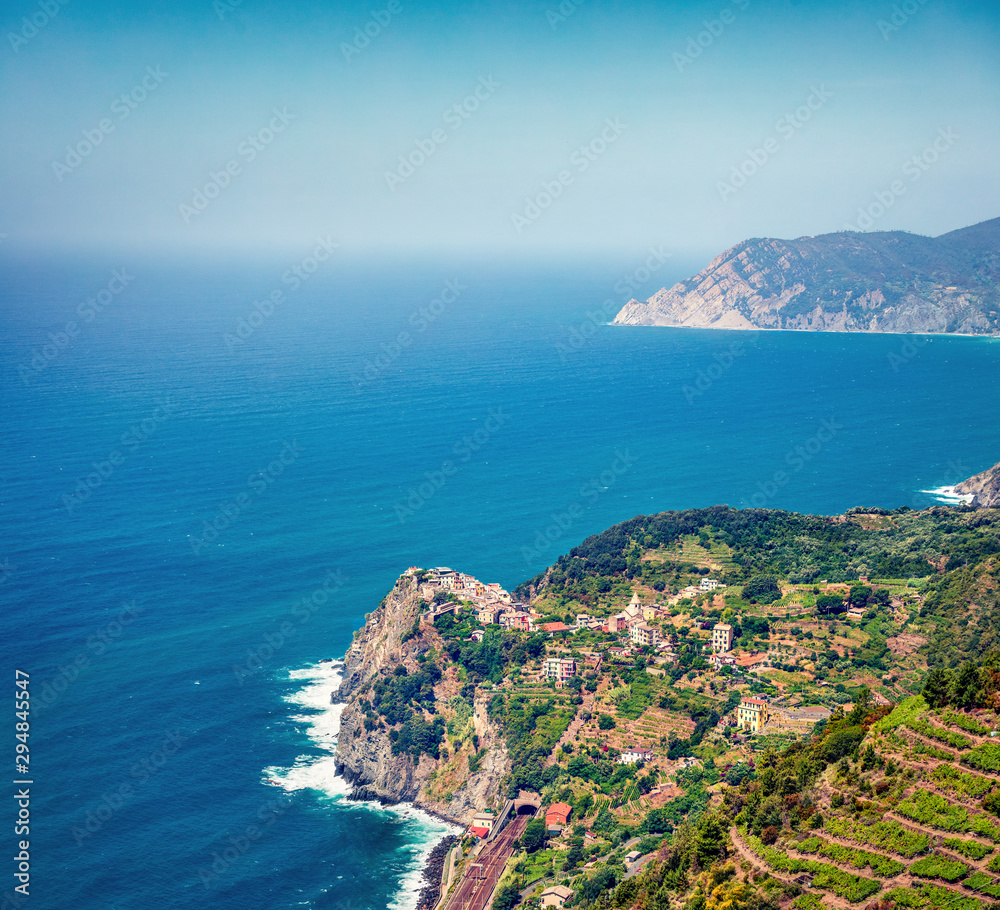 Third village of the Cique Terre sequence of hill cities - Corniglia. Colorful spring morning in Liguria, Italy, Europe. Picturesqie seascape of Mediterranean sea. Traveling concept background.