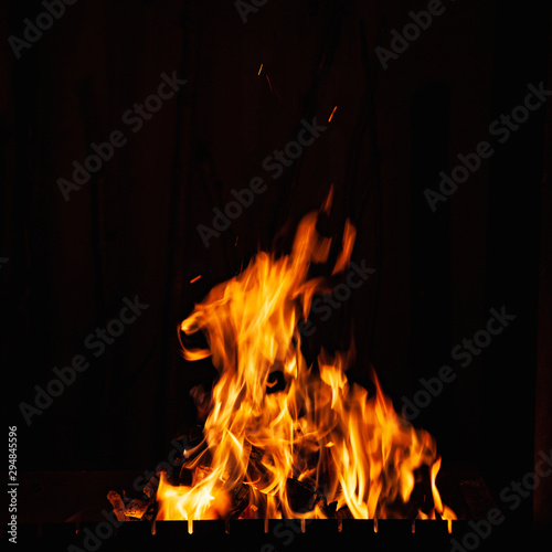 Flames. Fiery burning at night. A fire in the grill, fireplace and hearth.