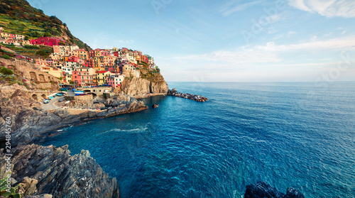 Fototapeta Naklejka Na Ścianę i Meble -  Second city of the Cique Terre sequence of hill cities - Manarola. Colorful spring morning in Liguria, Italy, Europe. Picturesqie seascape of Mediterranean sea. Traveling concept background.