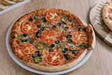 Fresh homemade vegetarian pizza with vegetables on wooden background