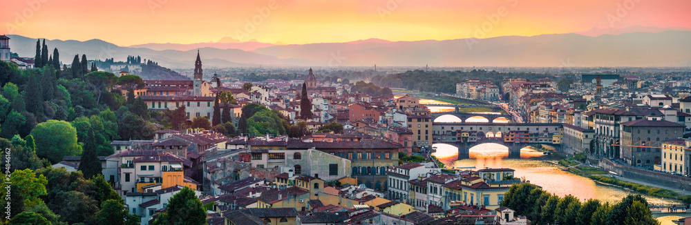 Panoramic evening cityscape of Florence, Italy, Europe. Beautiful medieval arched river bridges over Arno river.Traveling concept background.