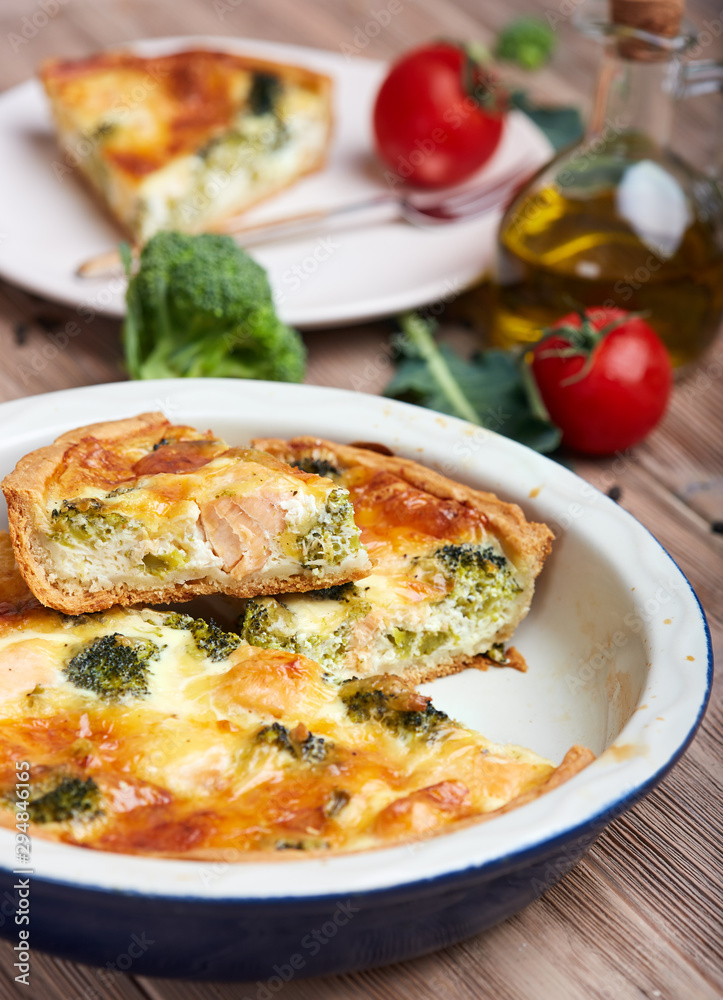 Quiche open tart pie with salmon fish, broccoli and cheese. Savory taste