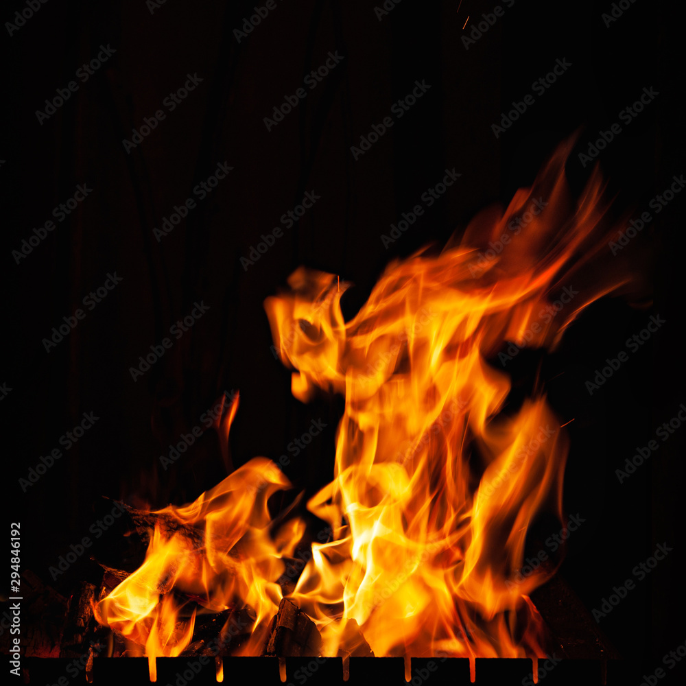 Fire flames. High burning fire at night. Strong fire in a grill, a fireplace and hearth. Fire flames. High burning fire at night. Strong fire in a grill, a fireplace and hearth.
