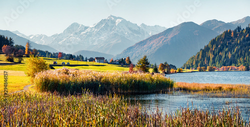 Panoramic autumn scene of Haidersee (Lago della Muta) lake with Ortler peak on background. Breathtaking morning view of Italian Alps, Italy, Europe.Beauty of nature concept background. © Andrew Mayovskyy