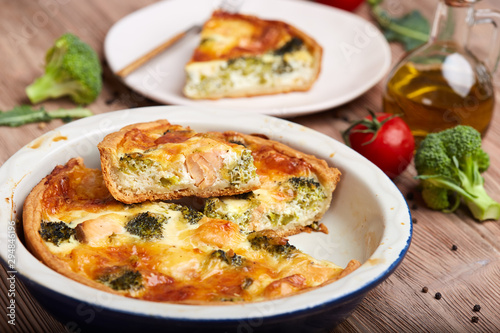 Quiche open tart pie with salmon fish, broccoli and cheese. Savory taste