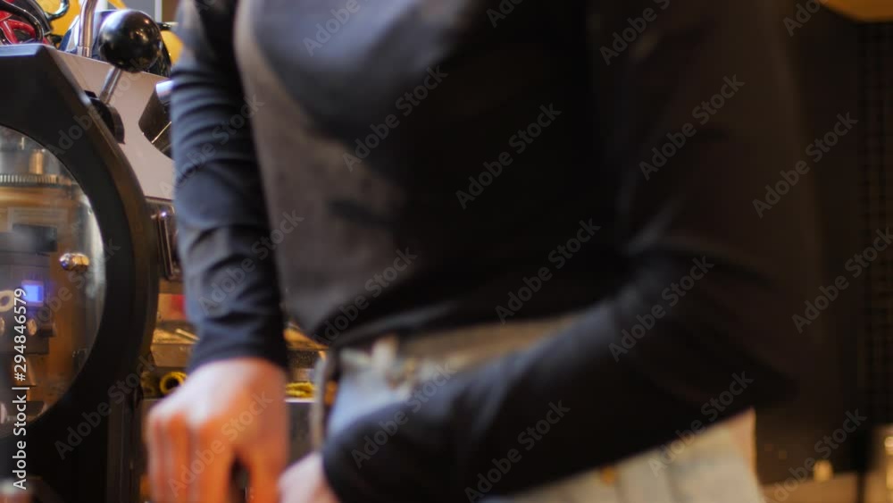 Barista girl makes coffee cup on espresso machine in a cafe bistro at the morning Barista girl makes coffee cup on espresso machine in a cafe bistro at the morning