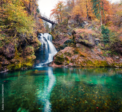 Amazing view of huge waterfall in Vintgar Gorge Canyon. Nice autumn scene of Triglav National Park, Julian Alps, Slovenia, Europe. Beauty of nature concept background..