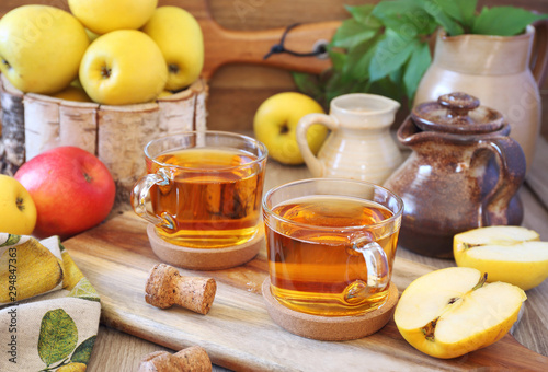 Two cups of Apple Cider and yellow apples