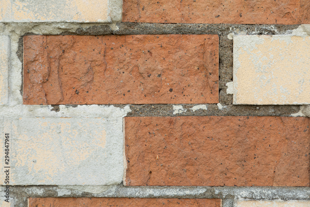 White and red brick wall with concrete in the gaps White and red brick wall with concrete in the gaps