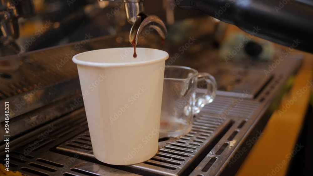 Barista girl makes coffee cup on espresso machine in a cafe bistro at the morning