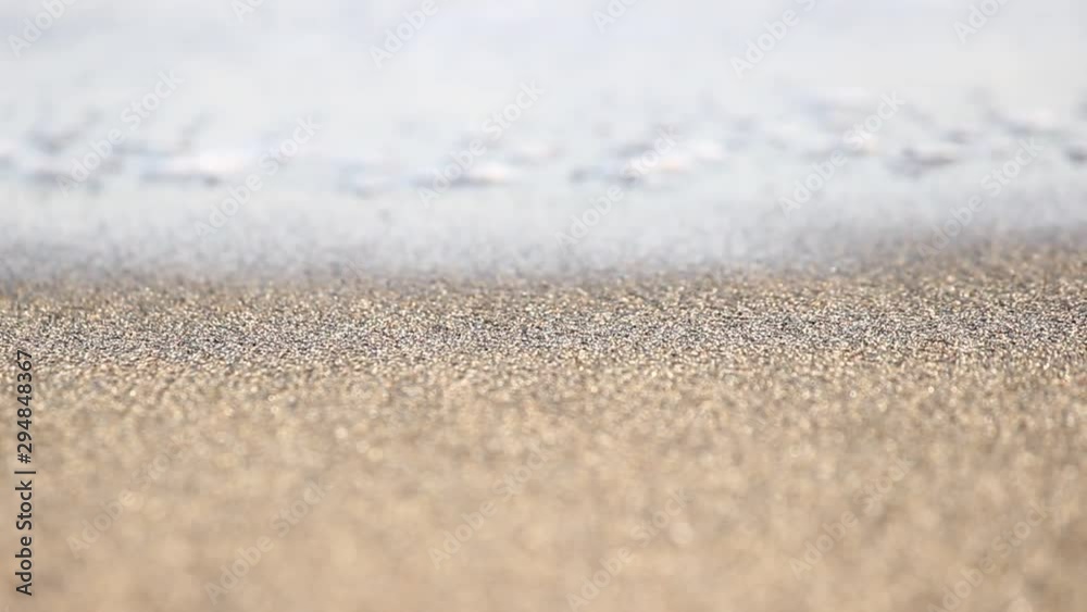 texture detail of the beach sand coming in contact with the water of a wave texture detail of the beach sand coming in contact with the water of a wave