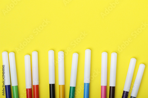 Multicolored markers at bright background 