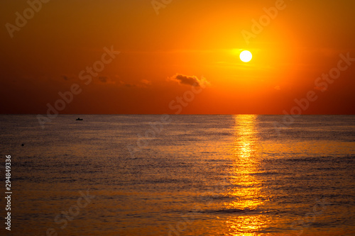 Fototapeta Naklejka Na Ścianę i Meble -  Summer sea sunset in Greece. Fisherman in boat.