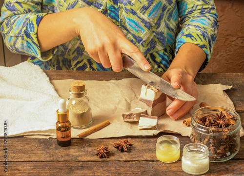 Woman hands cutting natural handmade soap with cocoa and cinnamon