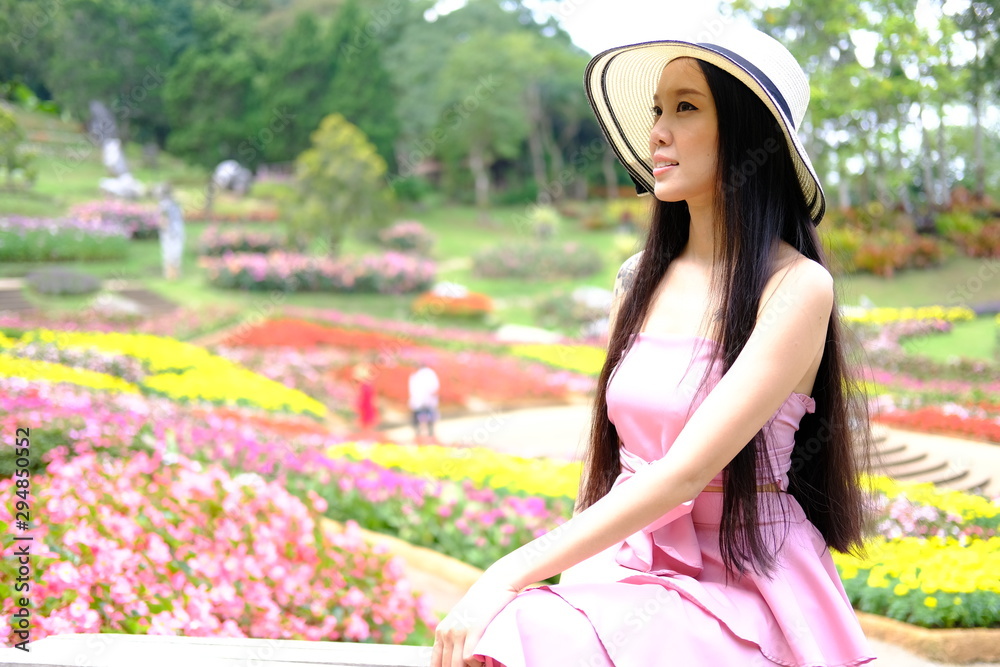 Fototapeta premium beautiful young woman relaxing in flower garden