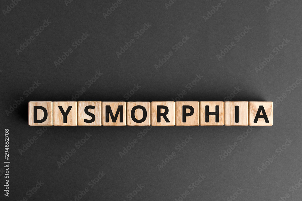 Dysmorphia - word from wooden blocks with letters, body dysmorphic disorder concept, gray background Dysmorphia - word from wooden blocks with letters, body dysmorphic disorder concept, gray background