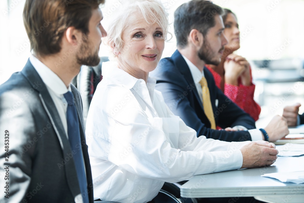 Portrait of smiling business woman looking at camera.
