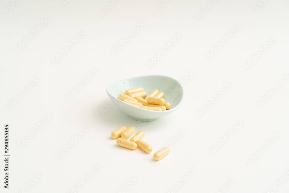 Yellow capsule pills on white background Yellow capsule pills on white background
