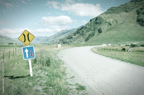 New Zealand gravel road in Mt Aspiring National Park. Retro filtered colors style.